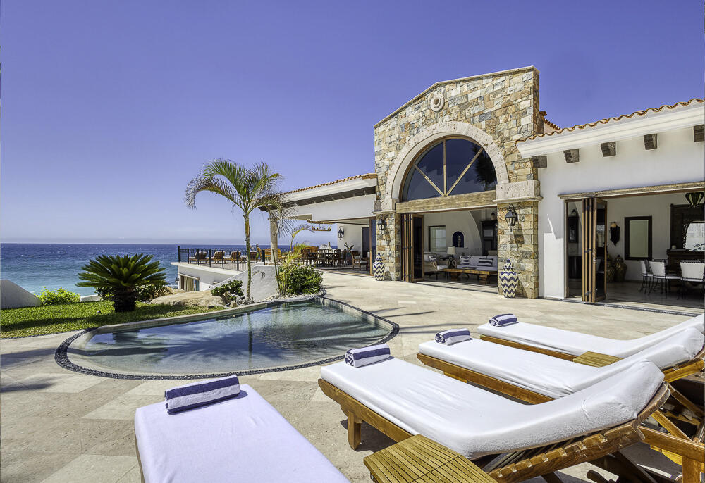 Cabo Luxury Rancholasmargaritas Casa Playa Escondida - Oceanfront Luxury in Baja California SurPerched dramatically on the rocks above the Pacific Ocean, Casa Playa Escondida is a rare oceanfront retreat set along a secluded, pristine stretch of beach. Located within the exclusive off-grid gated community of Rancho Las Margaritas, this one-of-a-kind property offers privacy, tranquility, and breathtaking natural beauty--just a 20-minute drive to the dining and shopping of Cabo San Lucas, 40 minutes from Los Cabos International Airport, and approximately 30 minutes south of Cerritos and Todos Santos.The residence features three spacious ensuite bedrooms, each privately situated yet connected by terraces, pathways, and shared gathering spaces. A dedicated media room offers flexibility as a fourth bedroom or additional guest suite.Expansive terraces and multiple lounging areas provide a variety of vantage points to take in the surrounding landscape, from the rugged coastline to the endless Pacific horizon.The gourmet kitchen is equipped with high-end appliances and designed for both functionality and style. A warm and inviting living and dining area, anchored by a striking fireplace, creates the perfect space for entertaining or relaxing with family and friends. The home is offered fully furnished with includes modern off-grid conveniences such as solar power.Outdoor living is equally exceptional, featuring a swimming pool, firepit, grilling area, and multiple seating spaces--ideal for enjoying the serene coastal setting for sale