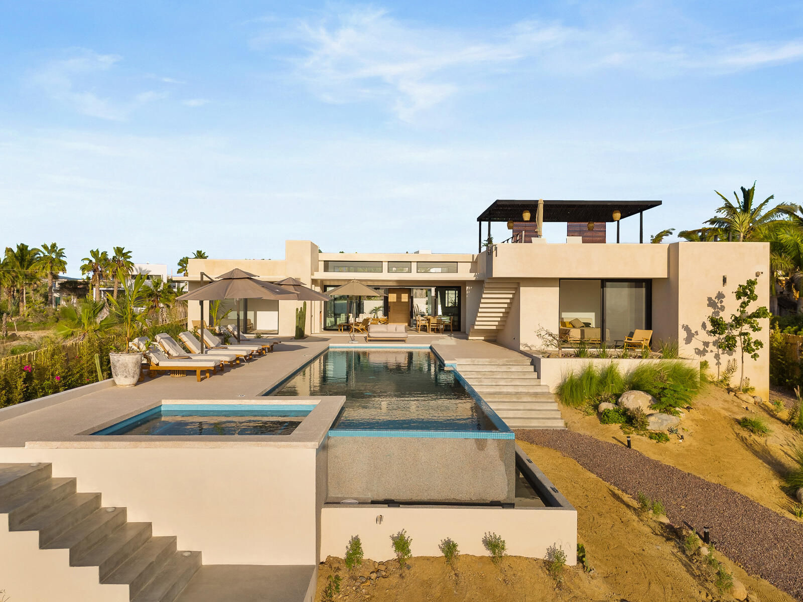 Cabo Luxury Las Tunas The Nacuii Residence is a refined luxury home crafted to exceed the expectations of even the most discerning buyer. Nestled on a generous and private 3,000 m² lot (0.73 acres), it's just a short, effortless stroll to the untouched, sandy shores of Las Tunas — perfect for enjoying the serene coastal landscape and dramatic sunsets. The home offers a thoughtful layout with 3 spacious bedrooms, a separate studio, a cozy TV lounge, and 6 full bathrooms, including two principal suites, a guest room, a detached studio, and a dedicated media or family room. Expansive sliding glass doors invite natural light throughout the interiors while showcasing tranquil garden for sale