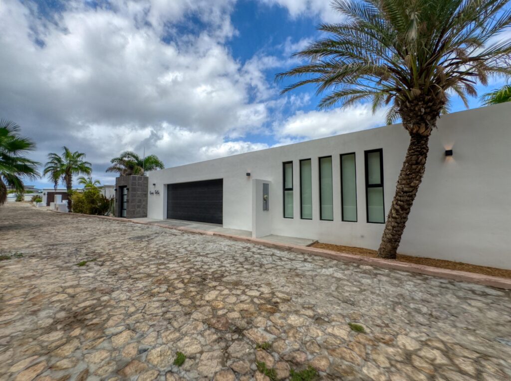 Cabo Luxury Las Tunas The Nacuii Residence is a refined luxury home crafted to exceed the expectations of even the most discerning buyer. Nestled on a generous and private 3,000 m² lot (0.73 acres), it's just a short, effortless stroll to the untouched, sandy shores of Las Tunas — perfect for enjoying the serene coastal landscape and dramatic sunsets. The home offers a thoughtful layout with 3 spacious bedrooms, a separate studio, a cozy TV lounge, and 6 full bathrooms, including two principal suites, a guest room, a detached studio, and a dedicated media or family room. Expansive sliding glass doors invite natural light throughout the interiors while showcasing tranquil garden for sale