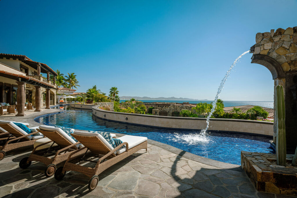 Cabo Luxury Palmilla Cove Villa Encanto, located at Palmilla Cove 5, offers a traditional design with hints of Old Hacienda Architecture, captured in the stone façade and archways throughout. The home offers a calming neutral palette, comfort, and practicality.A bit of wow comes into play with the 100' plus sprawling pool. Flowing the length of the home, the pool features a centrally located sunken spa, wet shelf, spitter fountains and cascading waterfall. Multi outdoor gathering spots are scattered throughout, offering places for lounging or leisurely long lunches, and even sneaking away to a quiet spot.The approach with the interior was to capture the ocean – Villa Encanto, Palmilla Cove 5, San Jose Corridor, San Jose Corridor, BS