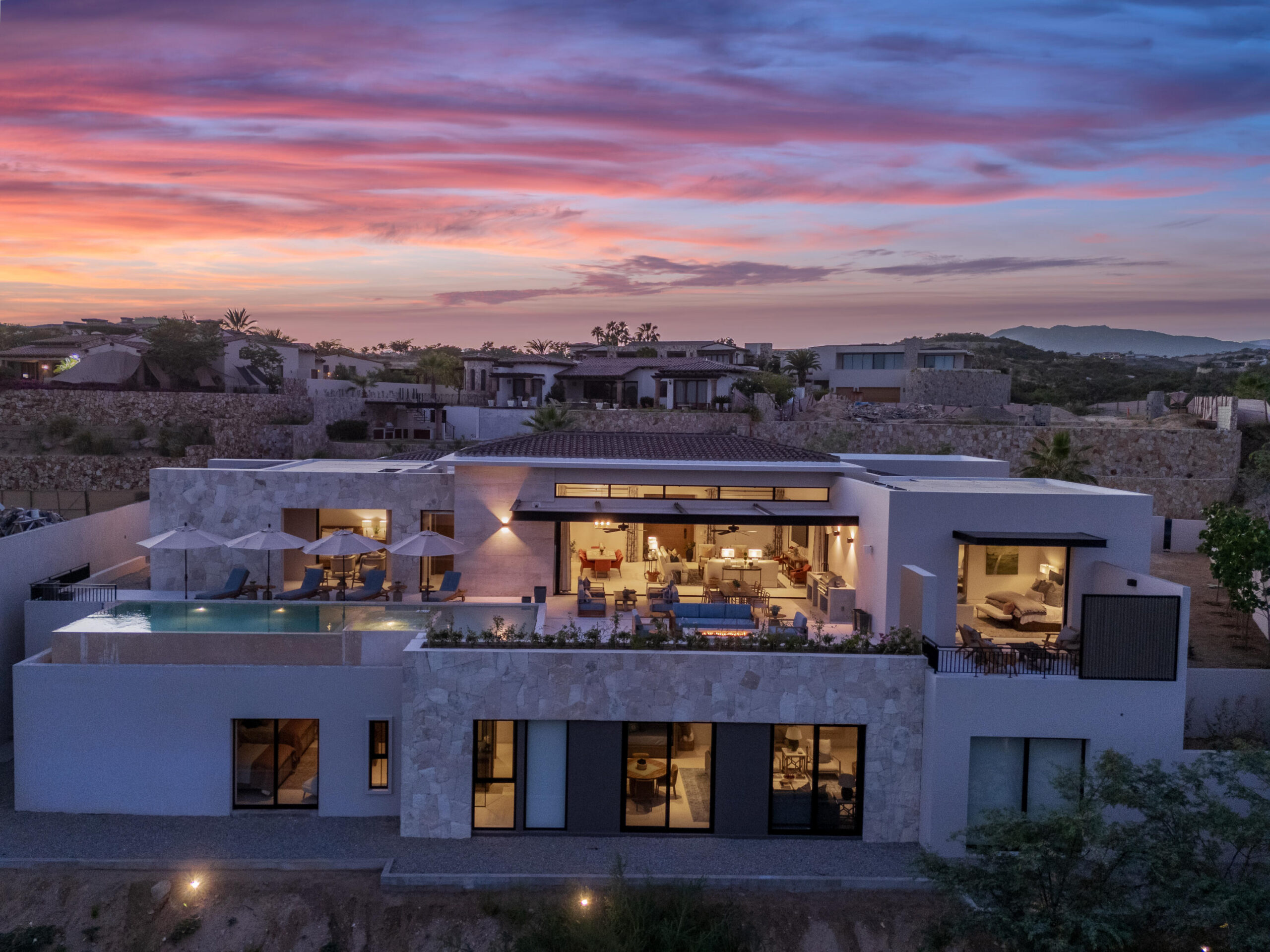 Cabo Luxury Section 18- Horizontes Welcome to Horizontes 3, an exquisite custom-made home located within San José del Cabo's most sought-after community, Querencia. Surrounded by Tom Fazio's signature golf course, recognized as one of the best in the country, this stunning residence is just a short golf cart ride from the prestigious 5-star Club House. This remarkable 6-bedroom, 6.5-bathroom home elevates luxury living with a fresh vision of architecture and design. The layout features a cozy family room, an expansive bunk bed bedroom on the lower level, and a spacious maid's quarters with an independent entrance, making it ideal for entertaining family and friends.The property boasts outdoor living spaces, including tranquil green areas, an outdoor kitchen, an infinity pool, a jacuzzi, and ocean and ravine for sale